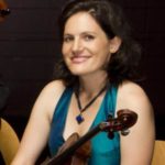 Person wearing a blue sleeveless top and holding a viola