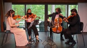 4 people playing instruments on stage